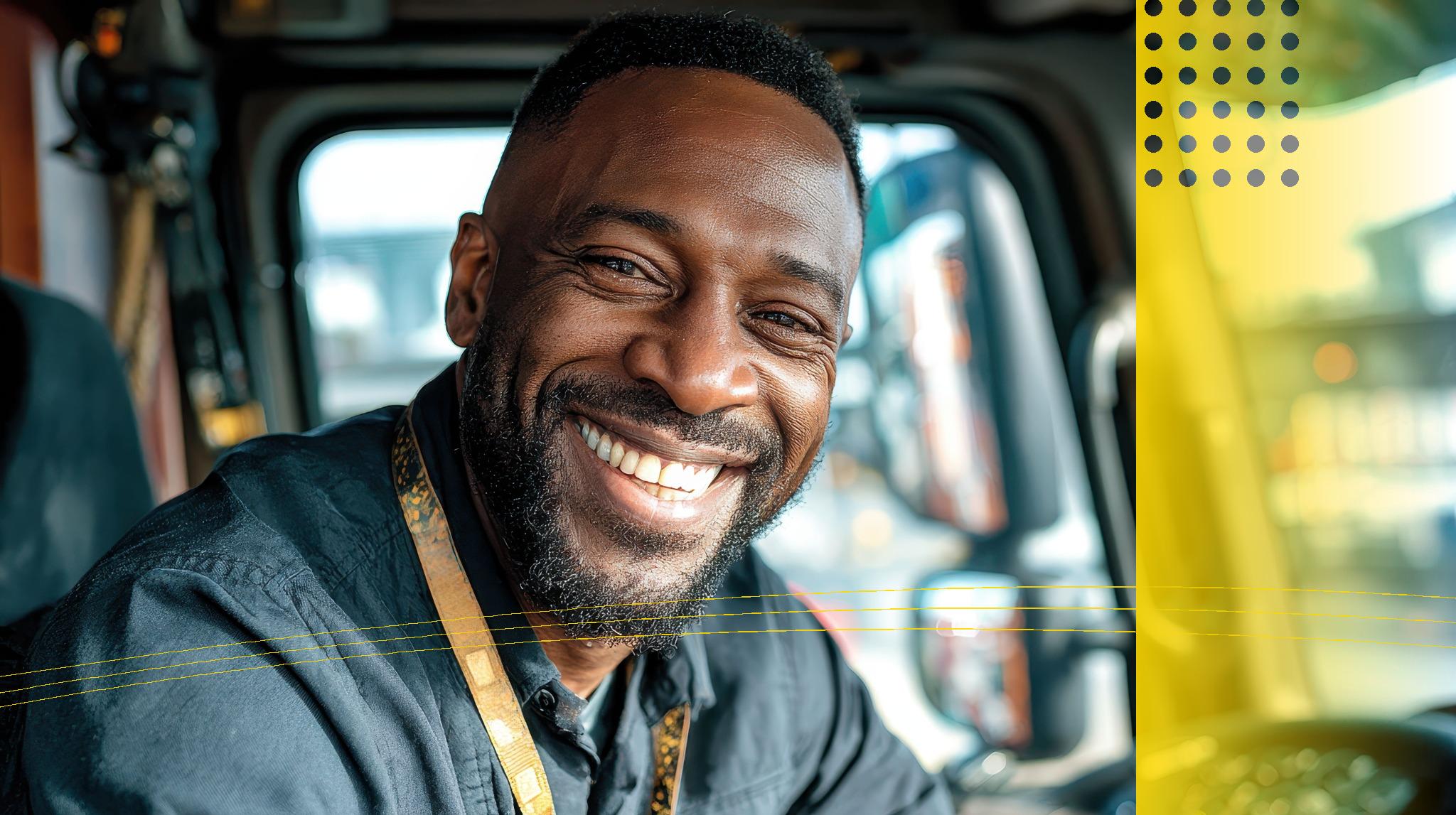 Smiling truck driver in work uniform sitting in truck cab